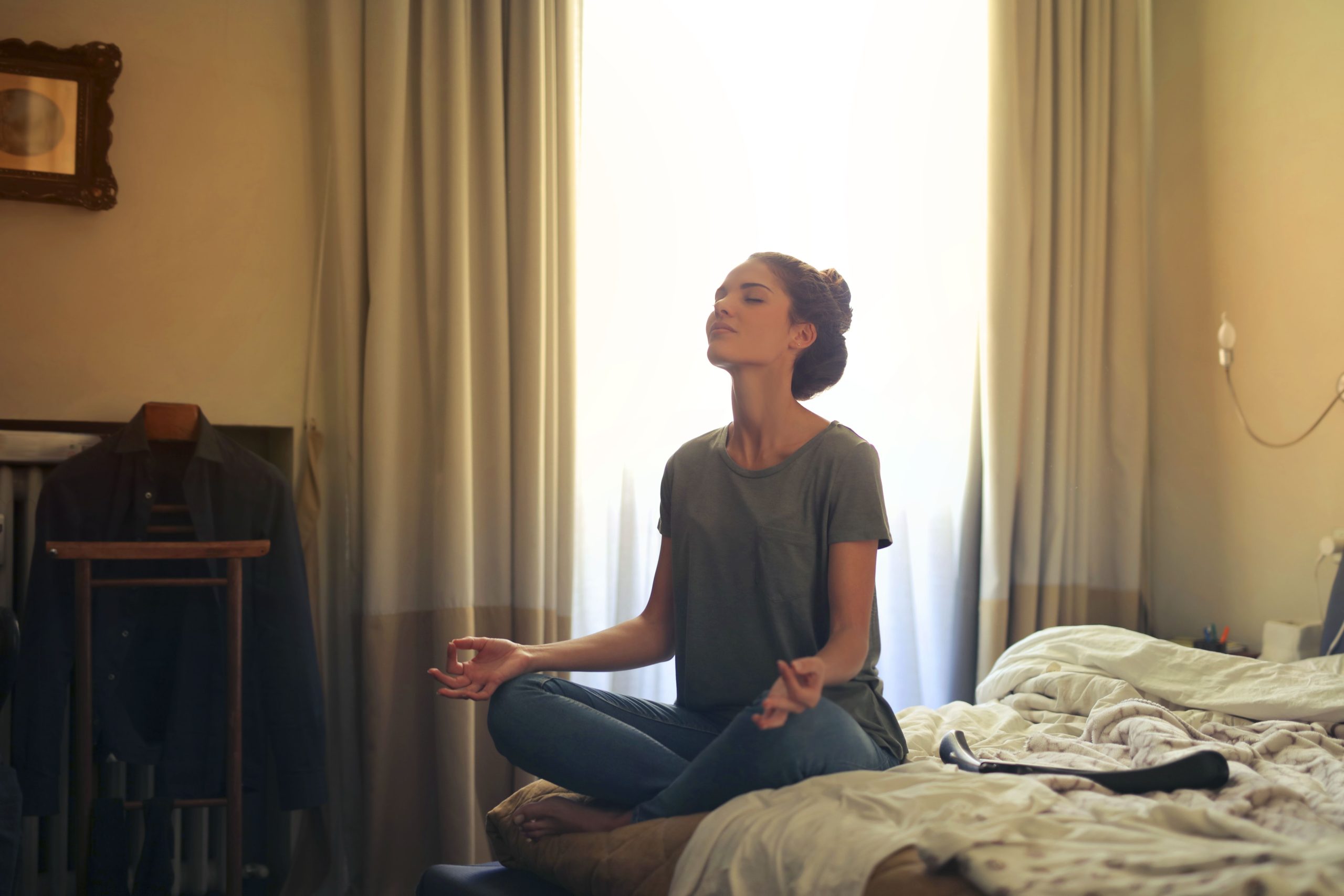 Femme adulte pratiquant méditation sur lit calme